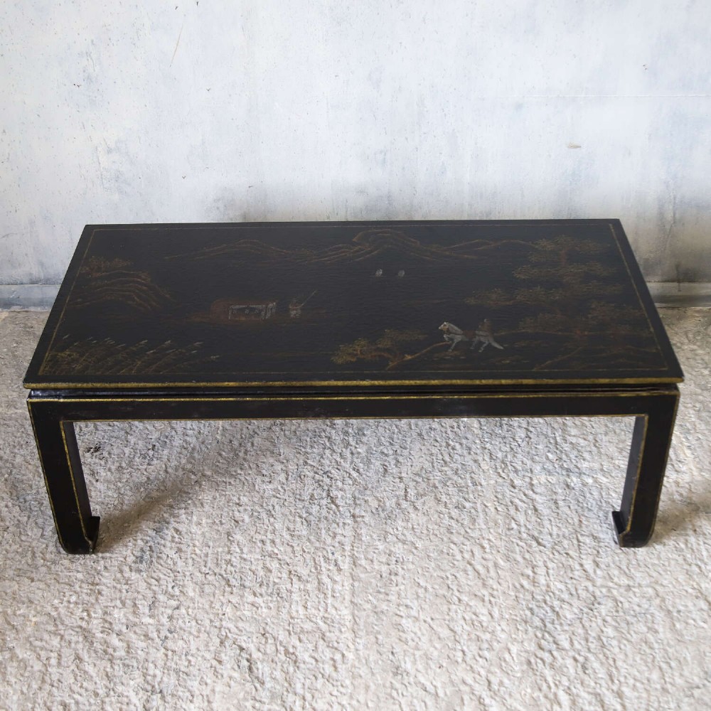 A low rectangular black japanned coffee table decorated with hand-painted gilt landscape scenes and supported by straight legs. View VIII