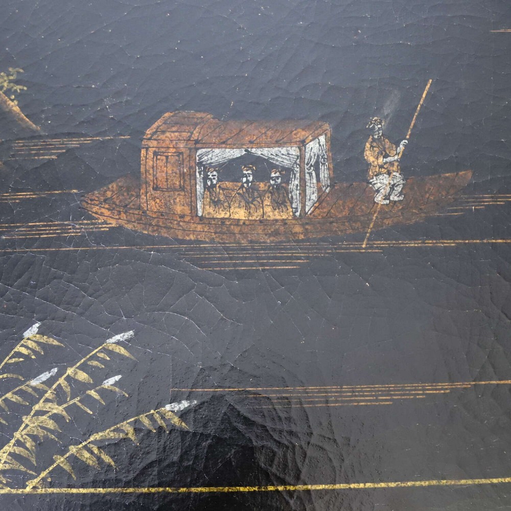 A low rectangular black japanned coffee table decorated with hand-painted gilt landscape scenes and supported by straight legs. View XII