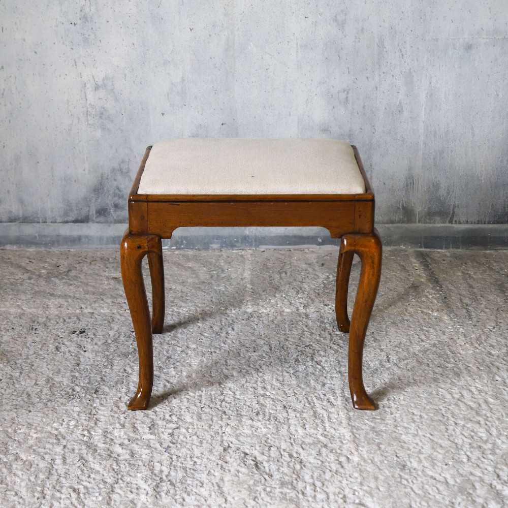 An early eighteenth-century George I walnut stool featuring four shaped cabriole legs and a cream upholstered drop-in seat. View III