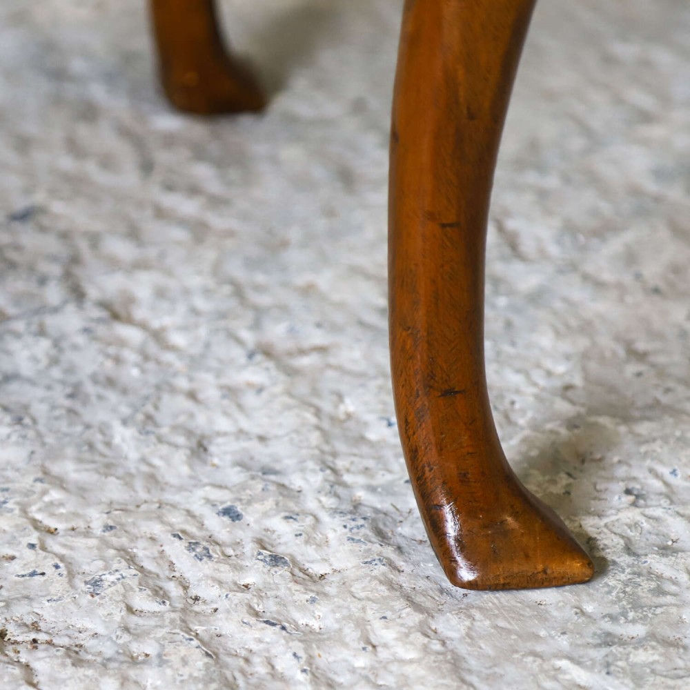 An early eighteenth-century George I walnut stool featuring four shaped cabriole legs and a cream upholstered drop-in seat. View VII