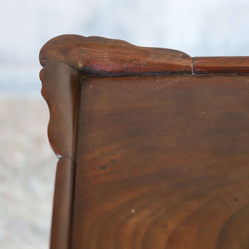 An early Georgian dark Cuban mahogany silver table featuring a raised tray top rim, single drawer with brass escutcheon, and slender cabriole legs terminating in pad feet. View VII