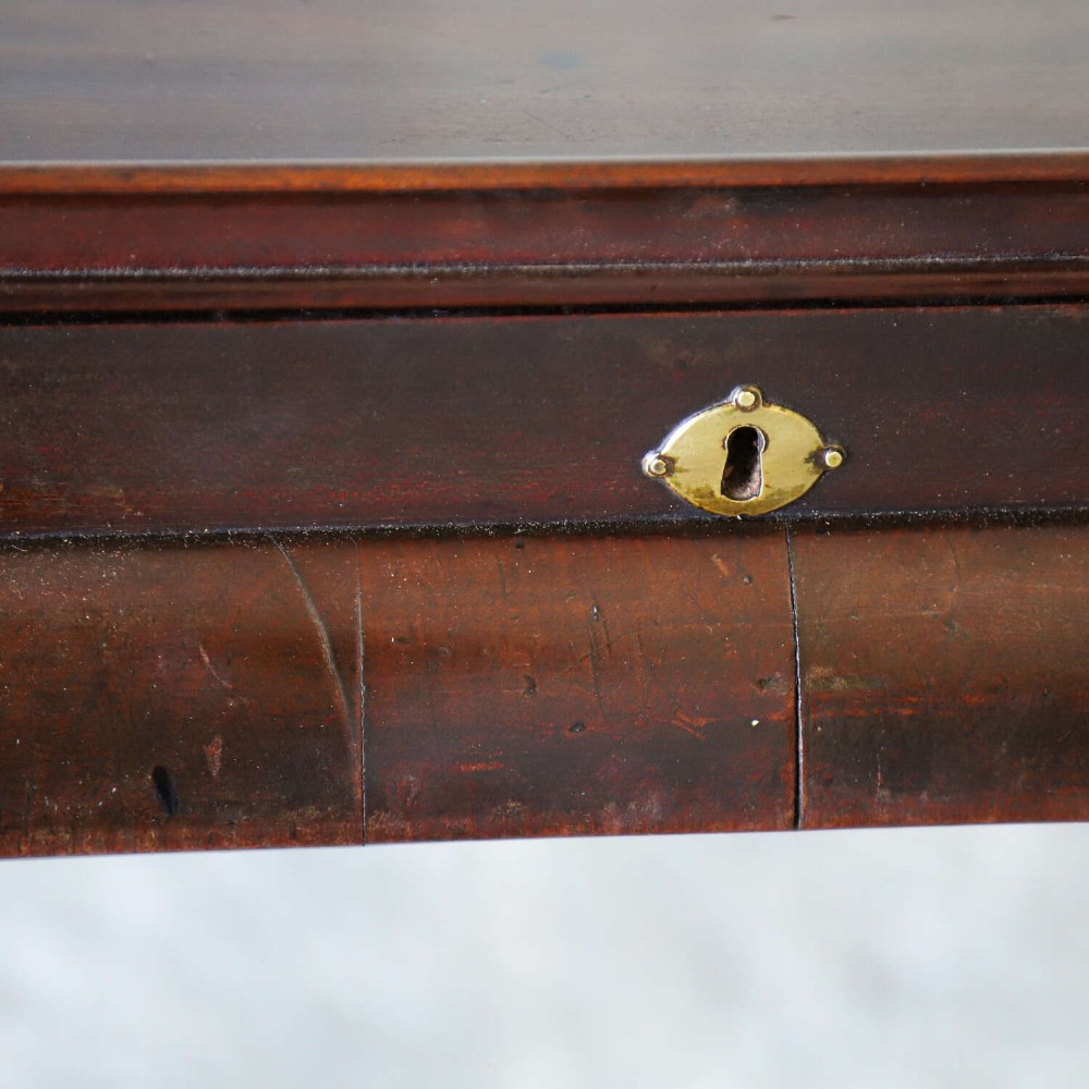 An early Georgian dark Cuban mahogany silver table featuring a raised tray top rim, single drawer with brass escutcheon, and slender cabriole legs terminating in pad feet. View XIII