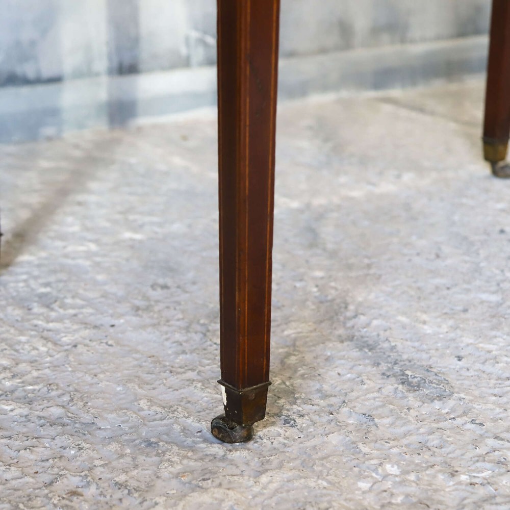 A late 18th-century Sheraton style mahogany Pembroke table with drop leaves, a single drawer, partridge wood crossbanding, and tapered legs on brass castors. View VI