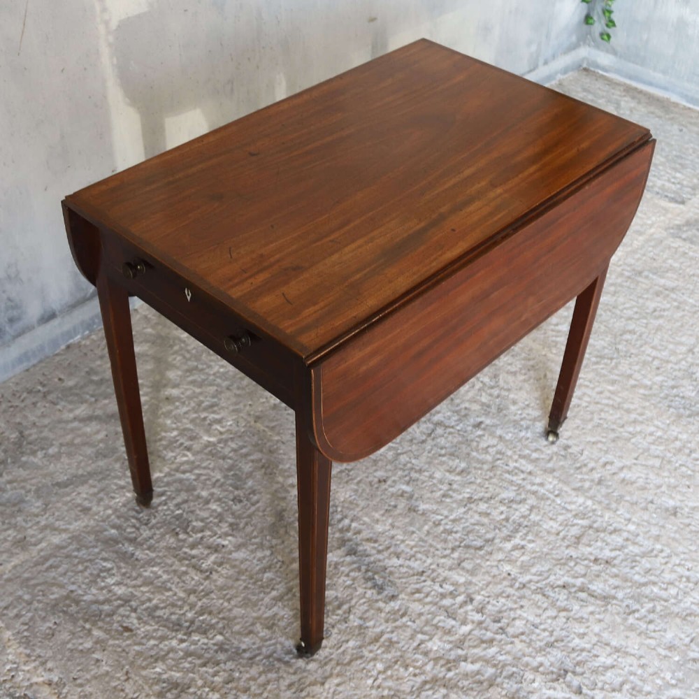 A late 18th-century Sheraton style mahogany Pembroke table with drop leaves, a single drawer, partridge wood crossbanding, and tapered legs on brass castors. View VIII