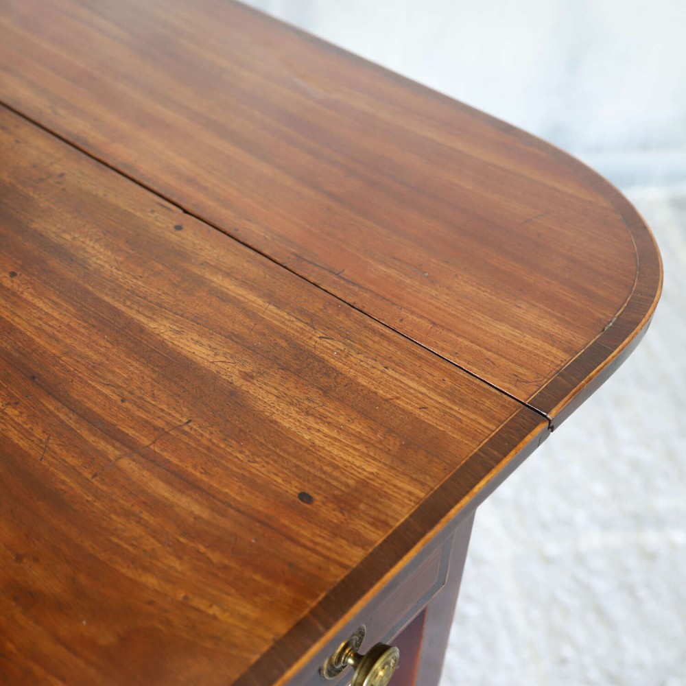 A late 18th-century Sheraton style mahogany Pembroke table with drop leaves, a single drawer, partridge wood crossbanding, and tapered legs on brass castors. View XI