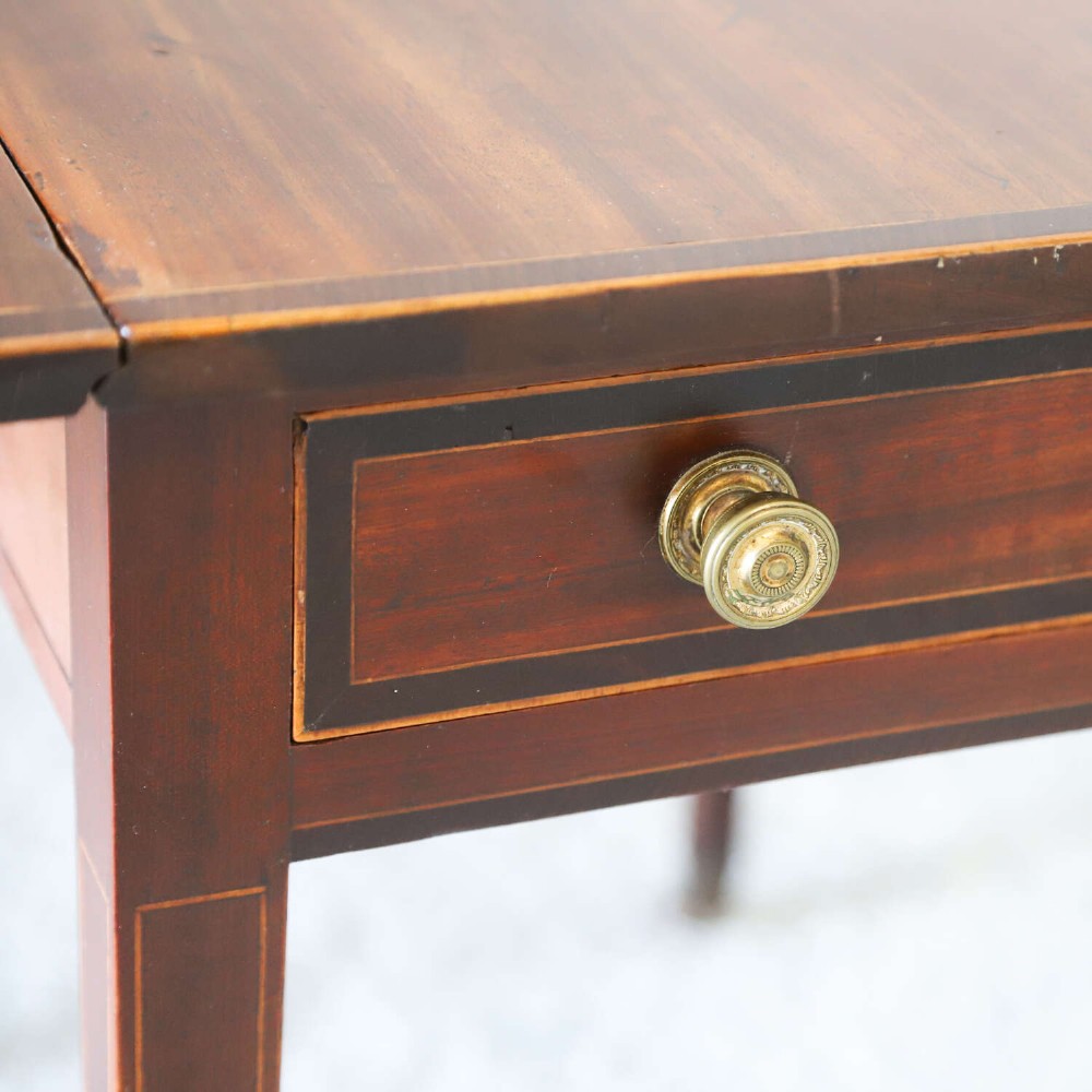 A late 18th-century Sheraton style mahogany Pembroke table with drop leaves, a single drawer, partridge wood crossbanding, and tapered legs on brass castors. View XII
