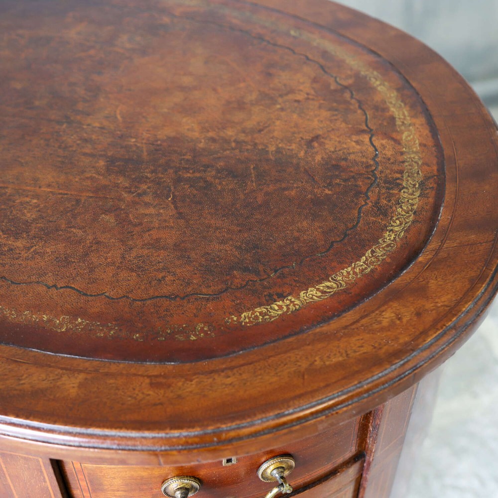 A late eighteenth-century Sheraton Revival mahogany kidney-shaped writing desk featuring a gilt-tooled leather top, nine drawers with brass handles, and line inlay. View VI