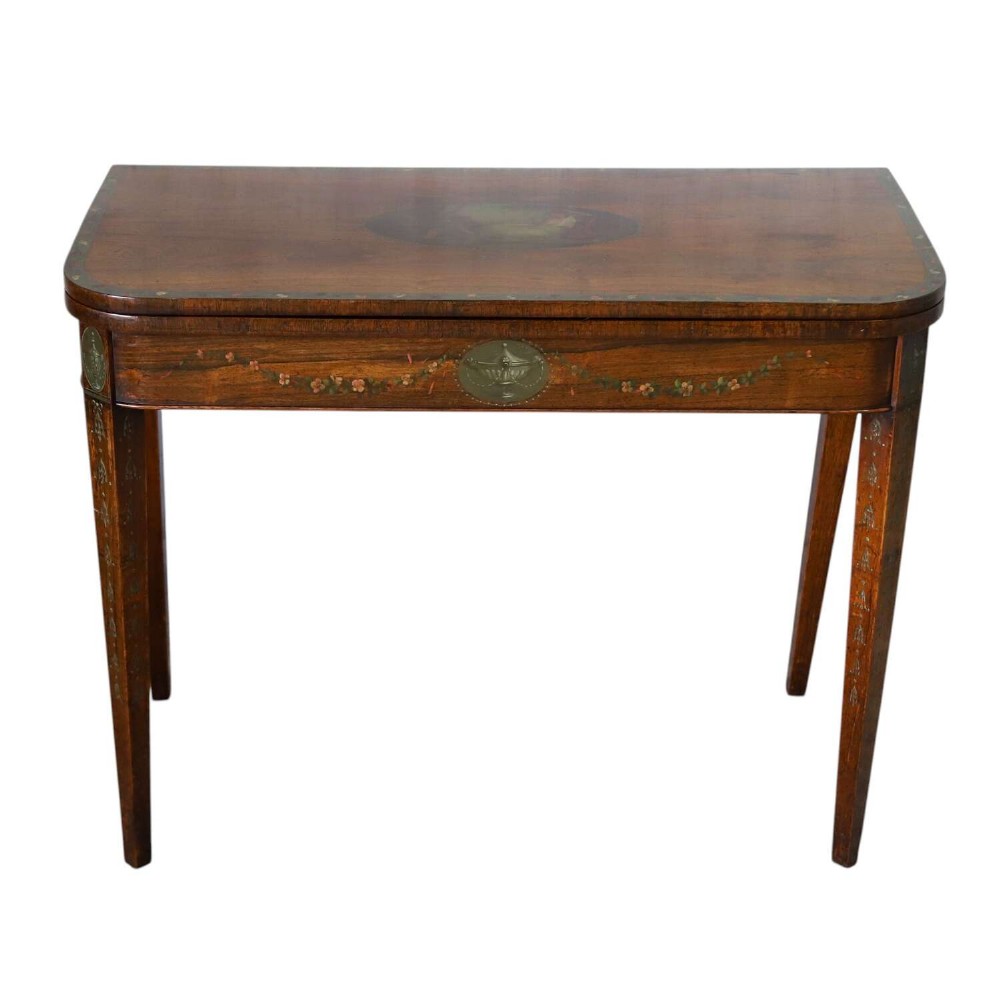 A Regency rosewood card table with a fold-over top, tapered legs, and hand-painted floral garland decoration along the apron.