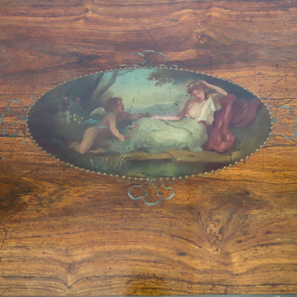 A Regency rosewood card table with a fold-over top, tapered legs, and hand-painted floral garland decoration along the apron. View IV