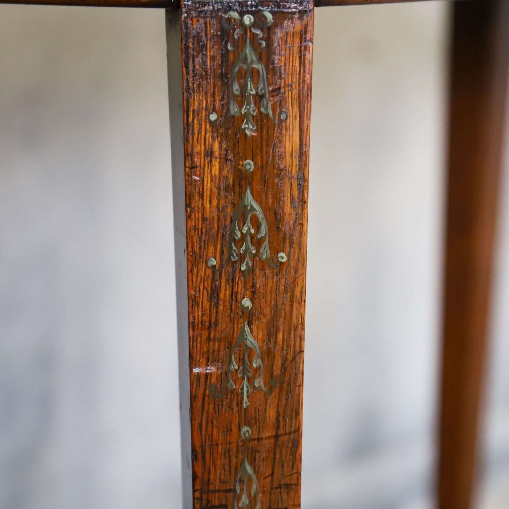 A Regency rosewood card table with a fold-over top, tapered legs, and hand-painted floral garland decoration along the apron. View VII