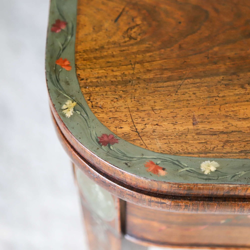 A Regency rosewood card table with a fold-over top, tapered legs, and hand-painted floral garland decoration along the apron. View IX