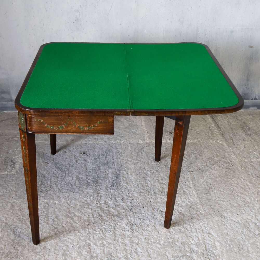 A Regency rosewood card table with a fold-over top, tapered legs, and hand-painted floral garland decoration along the apron. View XI