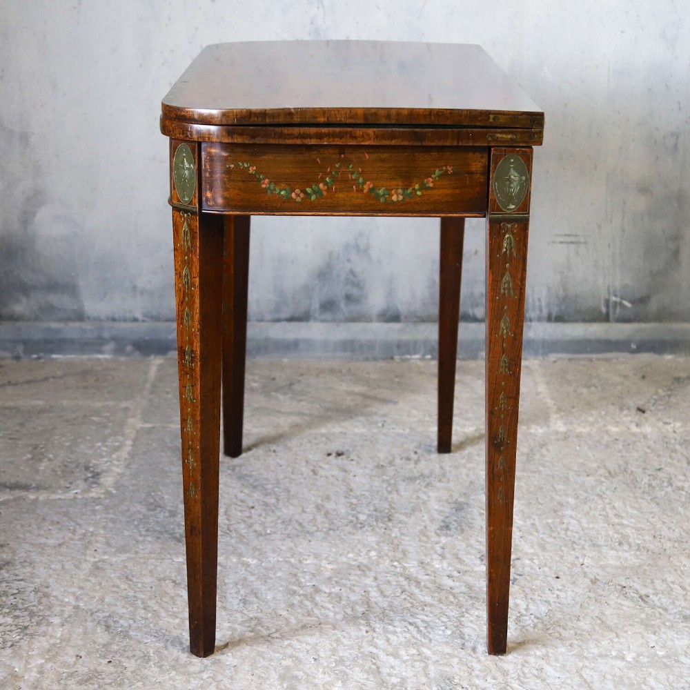 A Regency rosewood card table with a fold-over top, tapered legs, and hand-painted floral garland decoration along the apron. View XIII