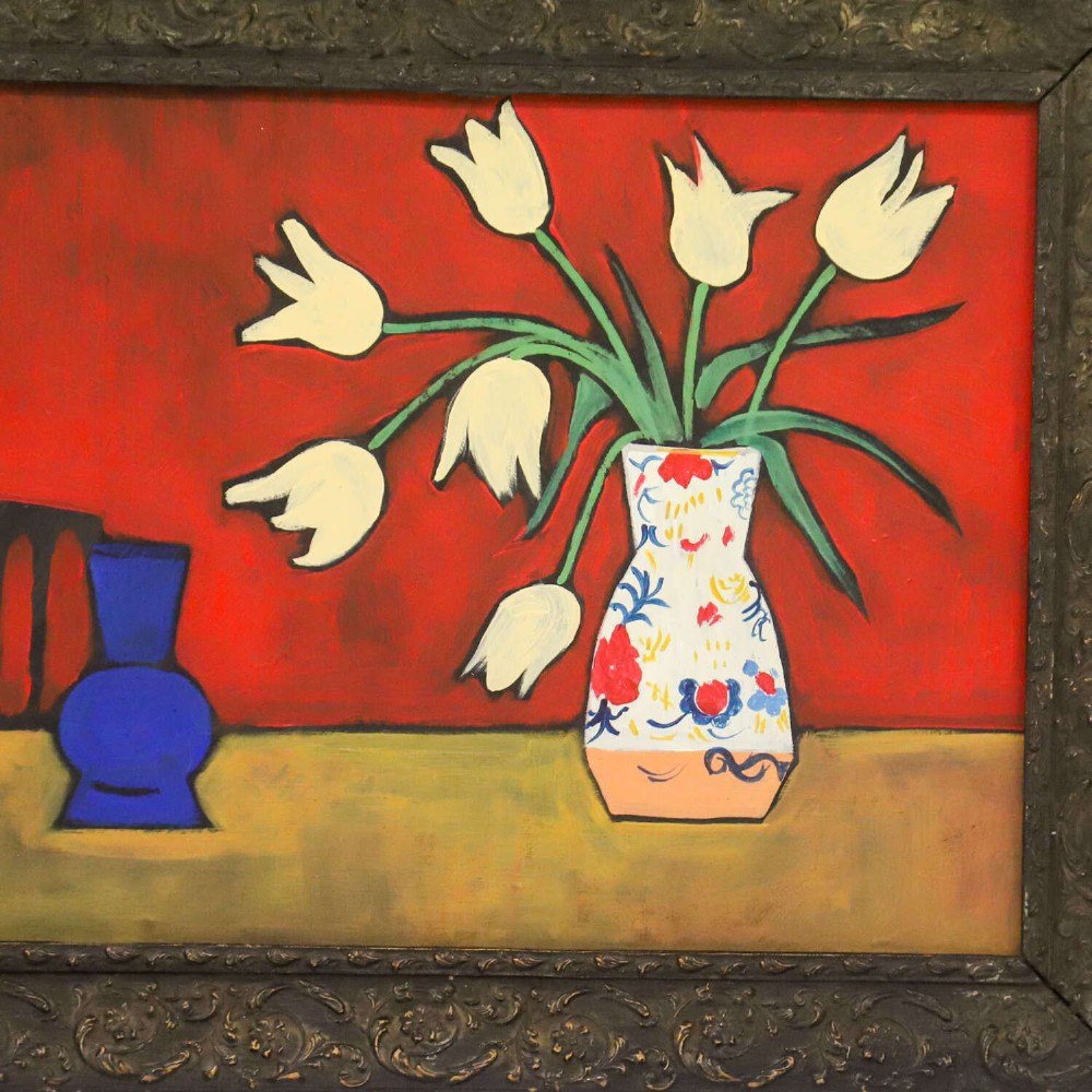 A 1930s Swedish still life oil painting depicting white tulips in a patterned ceramic vase next to a blue jug on a red background, set inside a carved dark wooden frame. View II