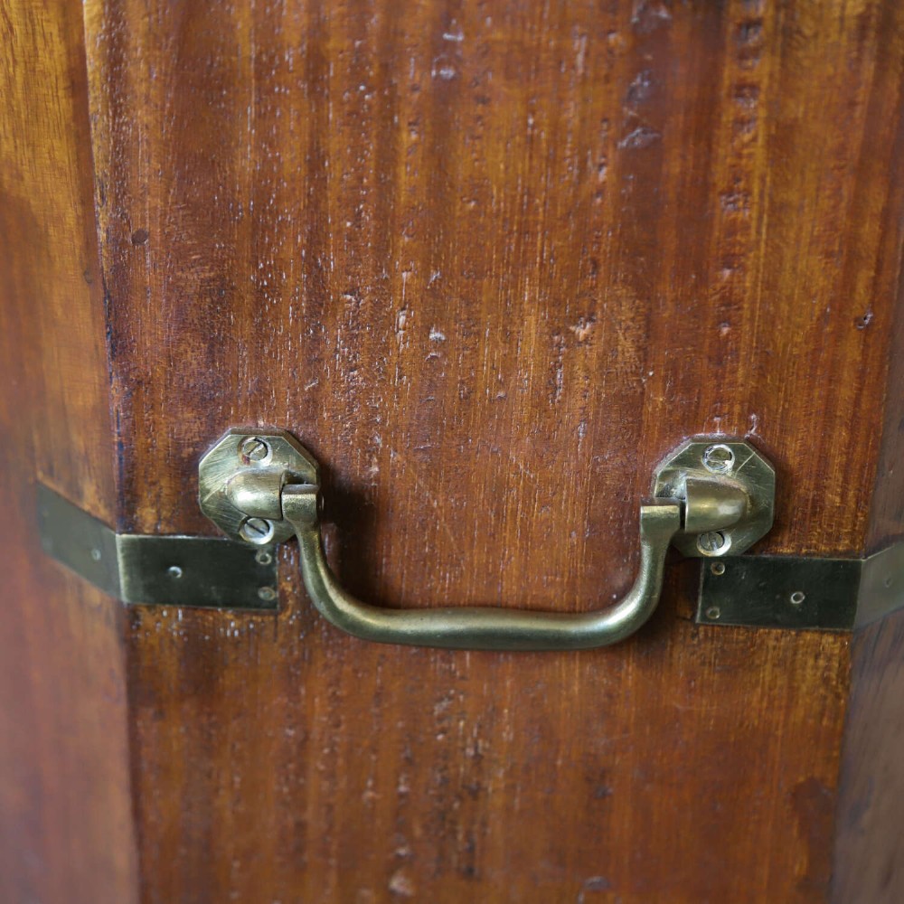 An octagonal antique wooden campaign chest featuring a hinged lift-up top, brass corner brackets, strapwork, and side carrying handles against a white background. View VIII