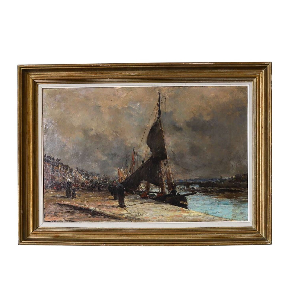 A 19th-century framed oil painting on canvas depicting sailboats moored along a harbour quay under a cloudy sky.