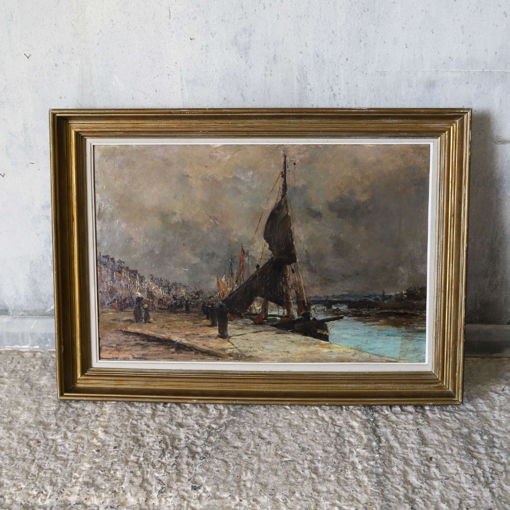 A 19th-century framed oil painting on canvas depicting sailboats moored along a harbour quay under a cloudy sky. View VI