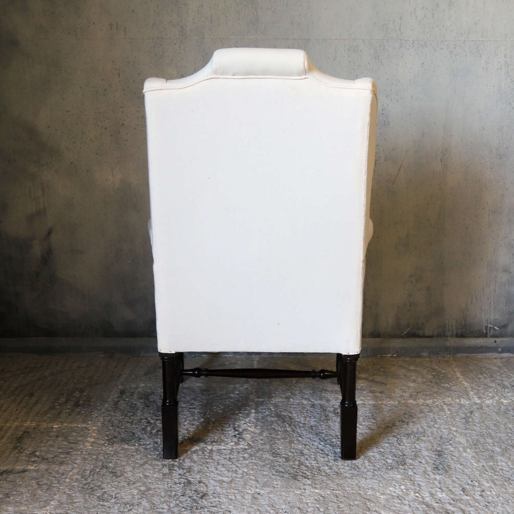 A 19th-century wingback armchair newly upholstered in plain cream calico fabric with dark carved timber cabriole front legs. View VII