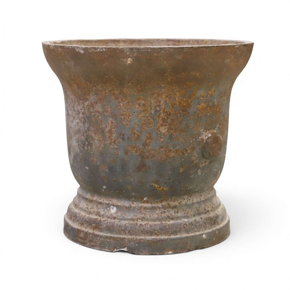 A nineteenth-century cast iron mortar featuring a flared upper rim, two side lug handles, and a moulded circular base with a patinated metal surface. View II