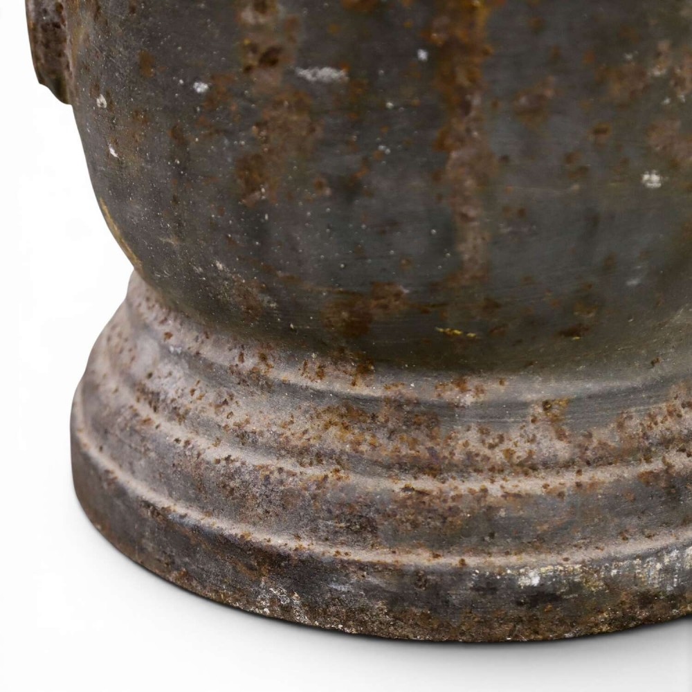 A nineteenth-century cast iron mortar featuring a flared upper rim, two side lug handles, and a moulded circular base with a patinated metal surface. View III