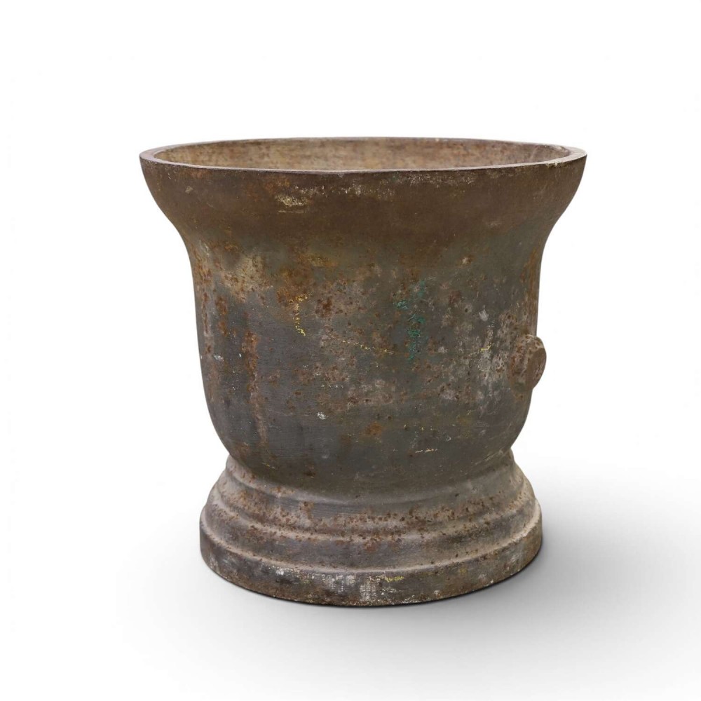 A nineteenth-century cast iron mortar featuring a flared upper rim, two side lug handles, and a moulded circular base with a patinated metal surface. View IV