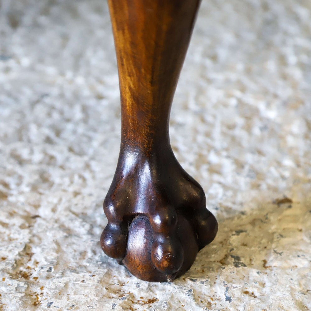 A Dutch walnut-veneered glazed cabinet featuring an arched top, glass paned upper doors, a shaped lower drawer section, and cabriole legs with claw and ball feet. View V