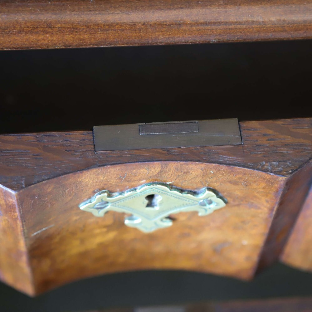 A Dutch walnut-veneered glazed cabinet featuring an arched top, glass paned upper doors, a shaped lower drawer section, and cabriole legs with claw and ball feet. View XII