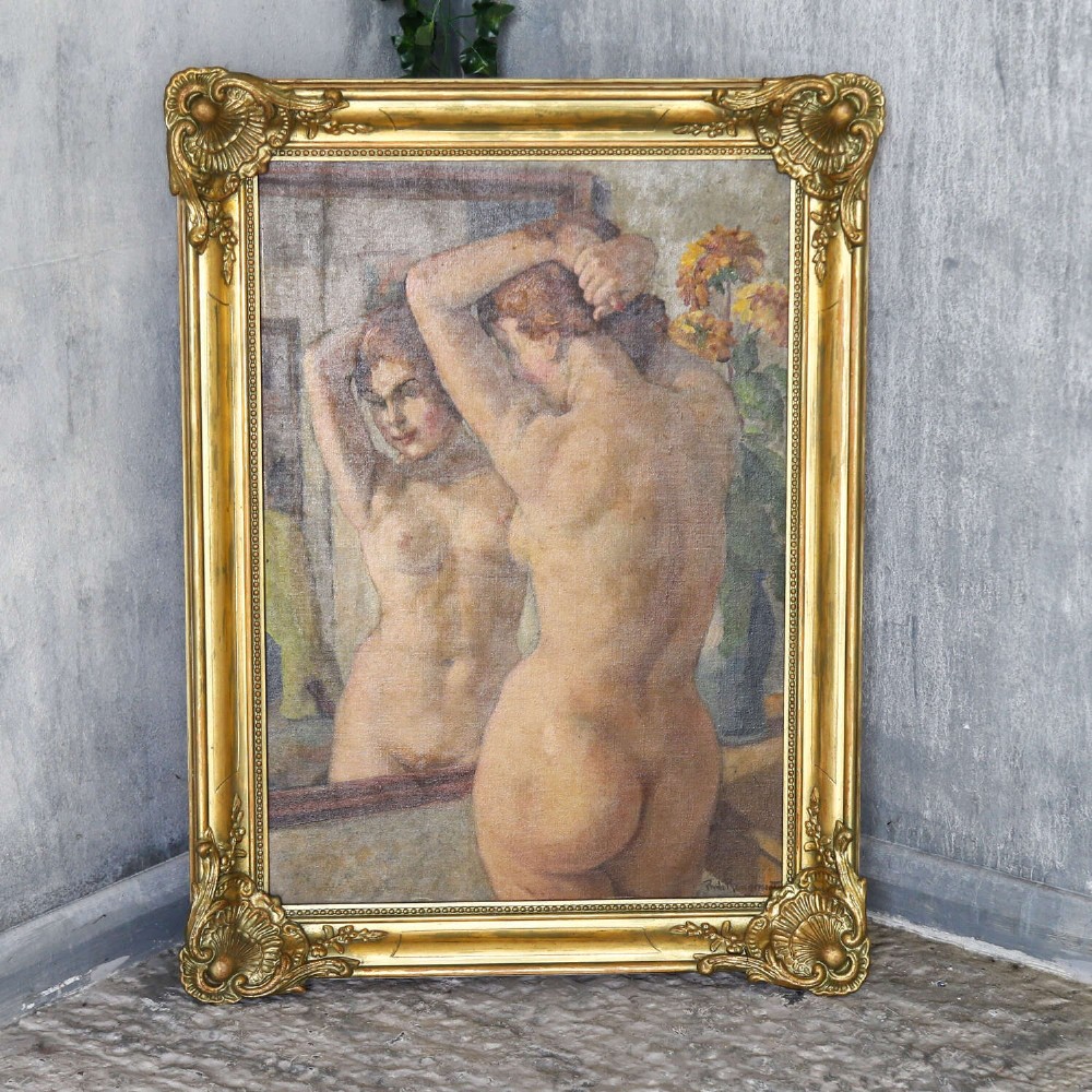 An oil painting on canvas depicting a female nude positioned before a mirror, presented inside an ornate gilded frame. View XI