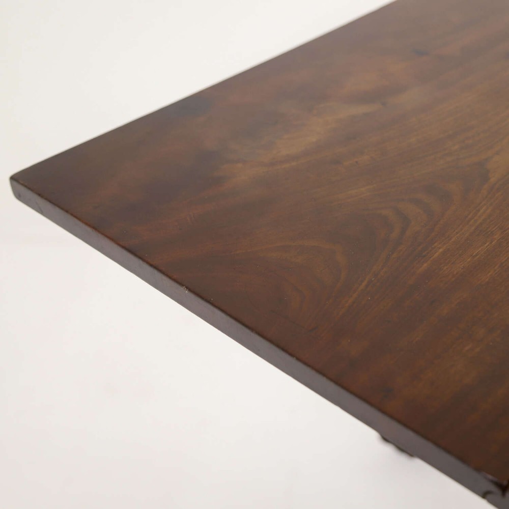 A George II mahogany drop-leaf dining table shown with leaves folded down, supported on four cabriole legs with carved claw-and-ball feet. View IX