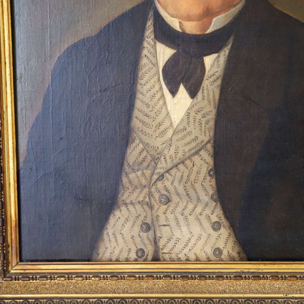 An antique oil painting depicting a male subject wearing a patterned waistcoat and black jacket, set in a gilded frame. View IV