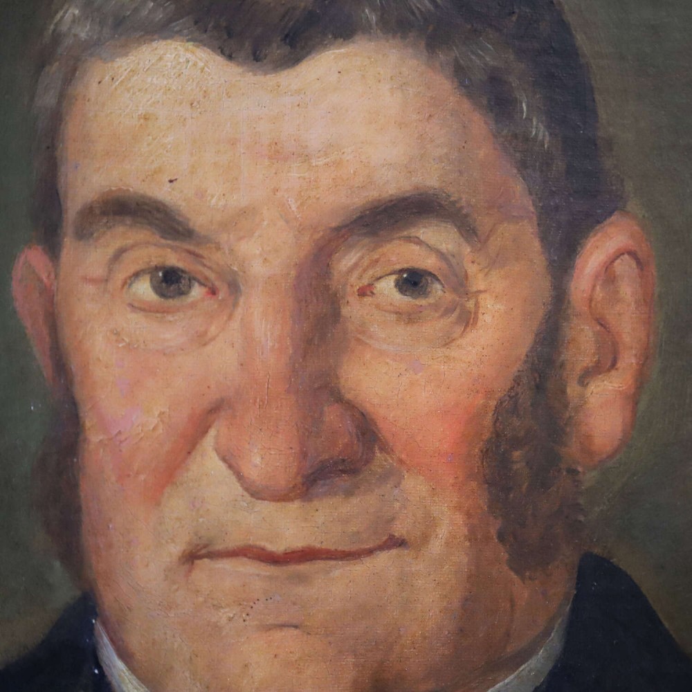 An antique oil painting depicting a male subject wearing a patterned waistcoat and black jacket, set in a gilded frame. View VI