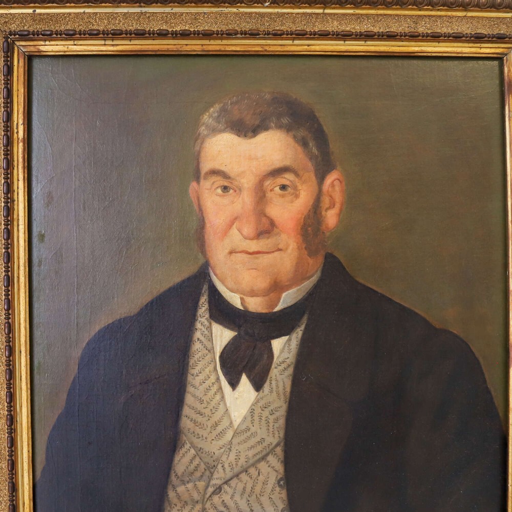 An antique oil painting depicting a male subject wearing a patterned waistcoat and black jacket, set in a gilded frame. View VII