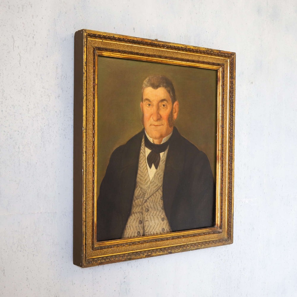 An antique oil painting depicting a male subject wearing a patterned waistcoat and black jacket, set in a gilded frame. View VIII