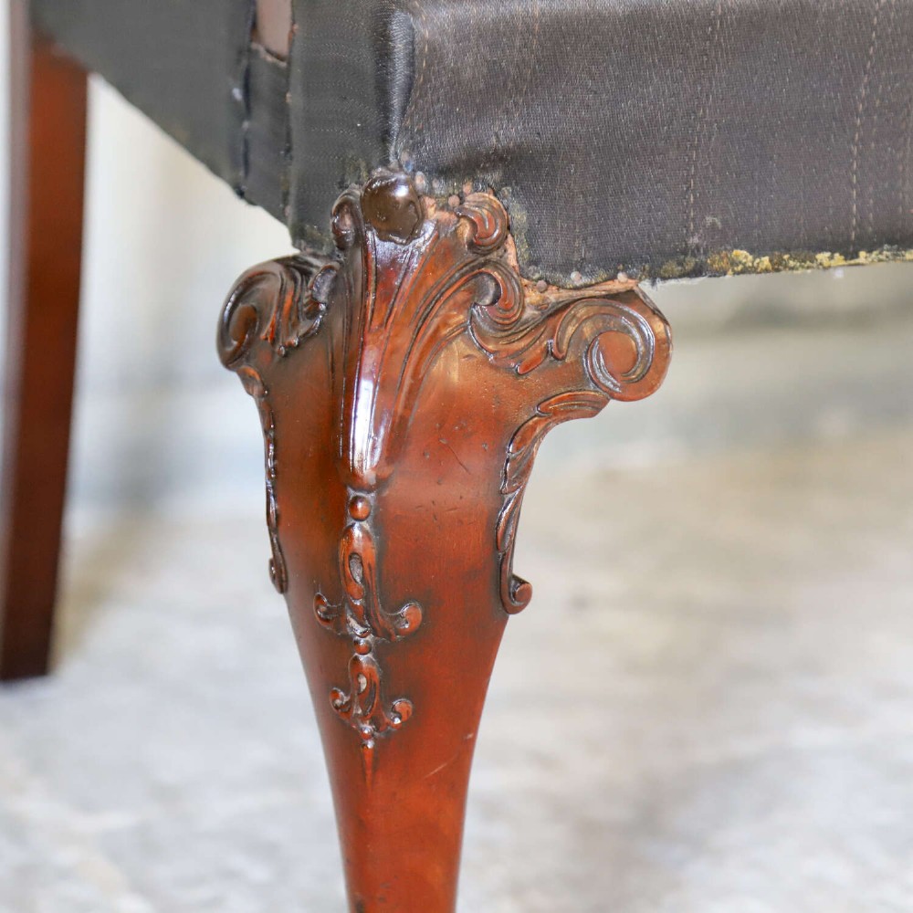 An Edwardian mahogany three-seater settee featuring three carved Chippendale-style pierced back splats, curved armrests, cabriole front legs with ball and claw feet, and a dark upholstered seat. View VI