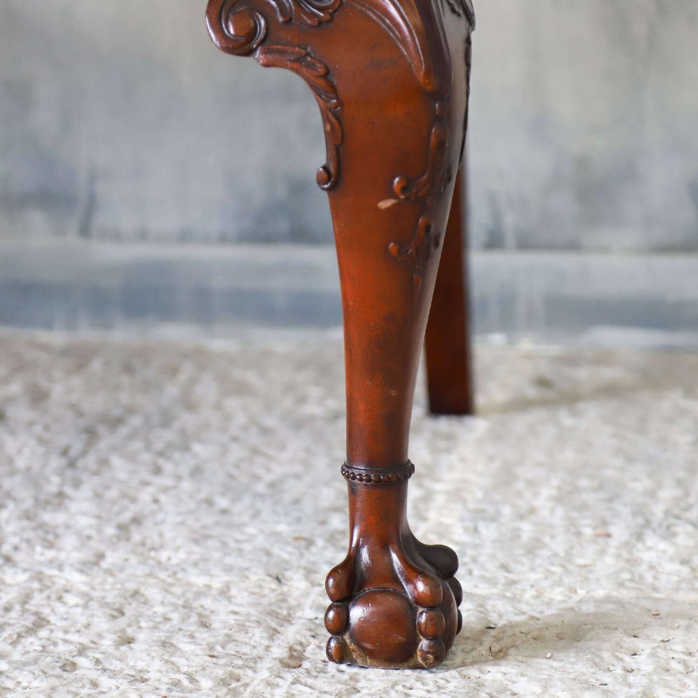 An Edwardian mahogany three-seater settee featuring three carved Chippendale-style pierced back splats, curved armrests, cabriole front legs with ball and claw feet, and a dark upholstered seat. View IX