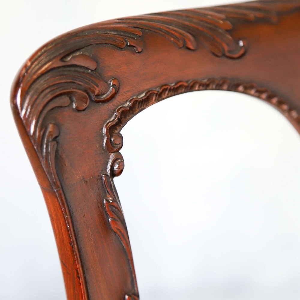 An Edwardian mahogany three-seater settee featuring three carved Chippendale-style pierced back splats, curved armrests, cabriole front legs with ball and claw feet, and a dark upholstered seat. View XIII