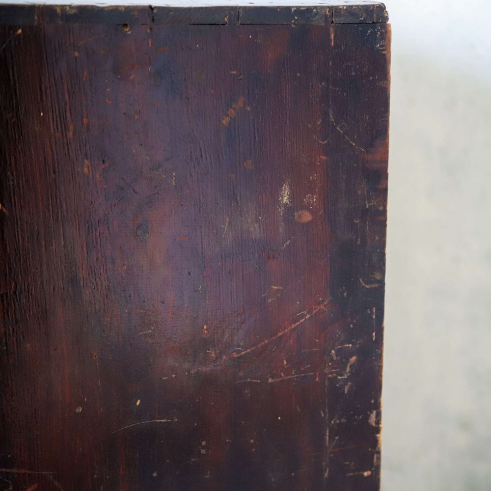 An antique Edwardian dark mahogany bank of twelve drawers featuring brass shell cup handles and label holders. View XII