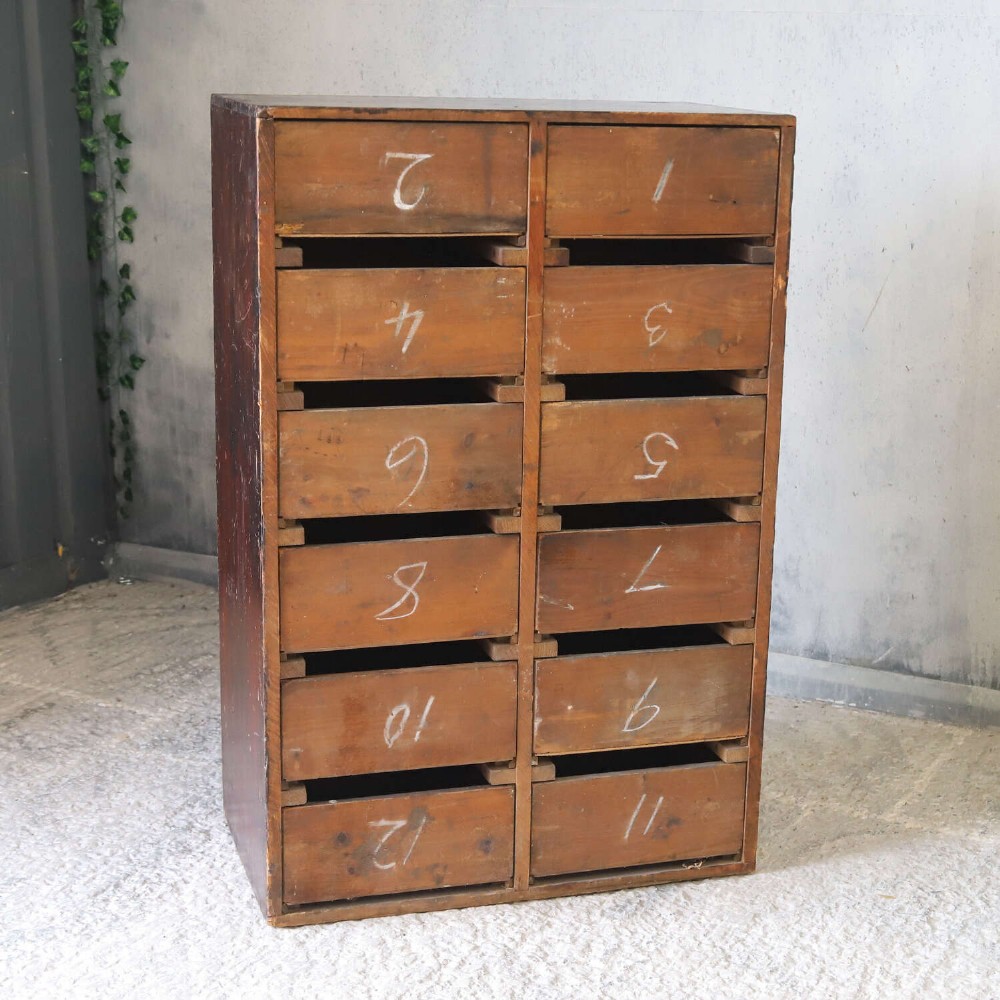An antique Edwardian dark mahogany bank of twelve drawers featuring brass shell cup handles and label holders. View XIII