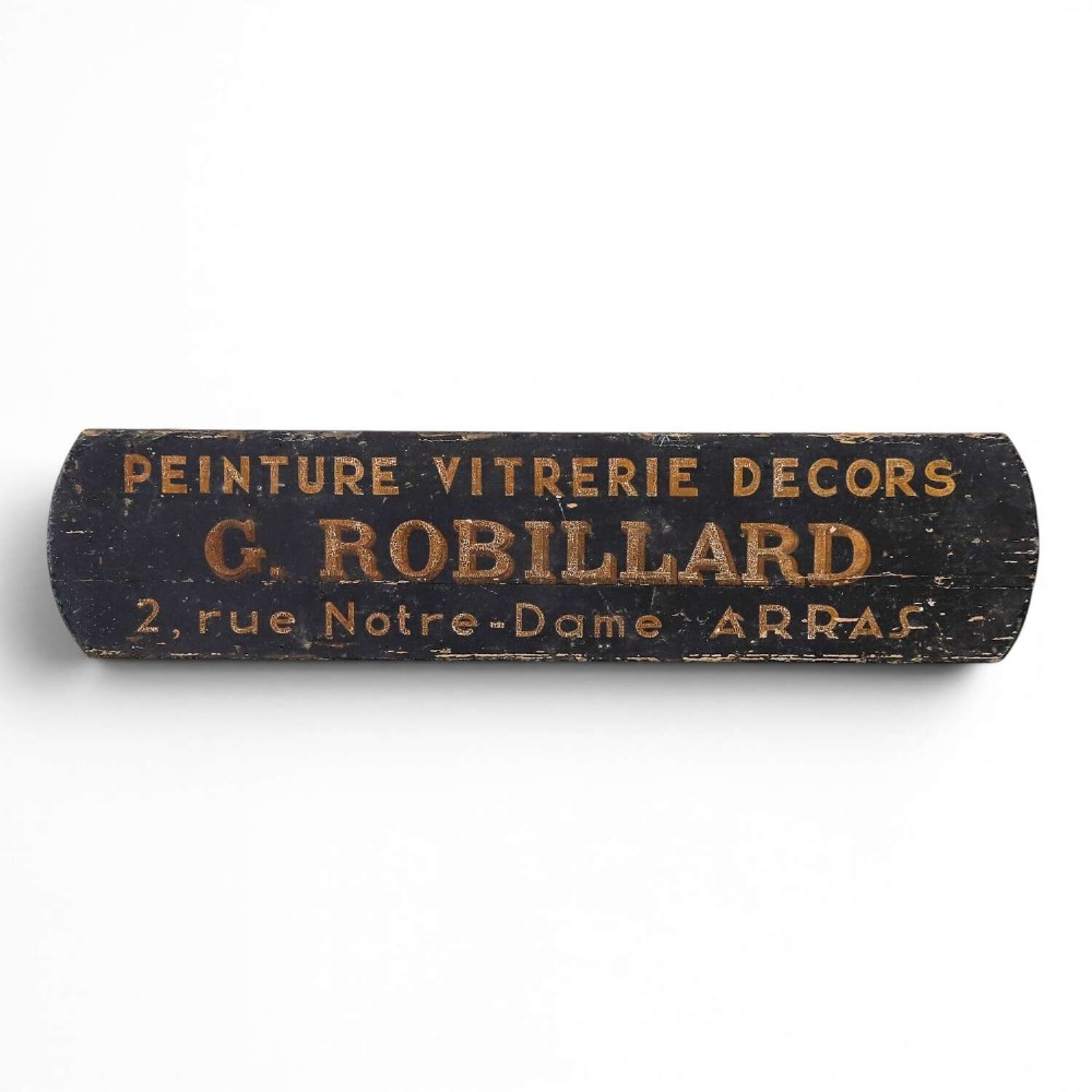 A rectangular black painted timber trade sign featuring gold hand-painted French text reading Peinture Vitrerie Decors G. Robillard Arras.