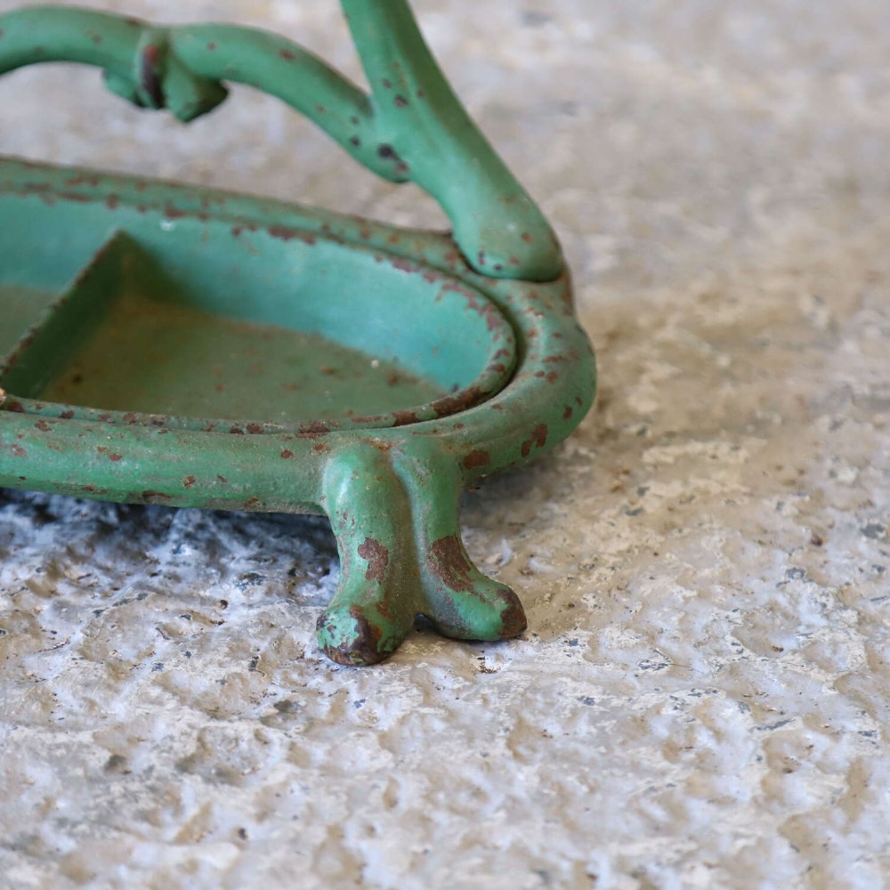 A green painted cast iron umbrella stand featuring a faux bois bamboo framework and an oval drip tray base. View VIII