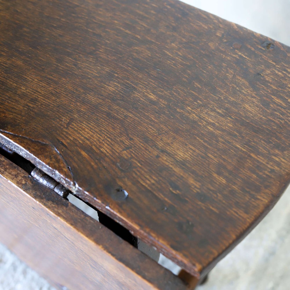A dark oak gateleg table featuring two hinged drop leaves, bobbin turned legs, and lower box stretchers. View VI
