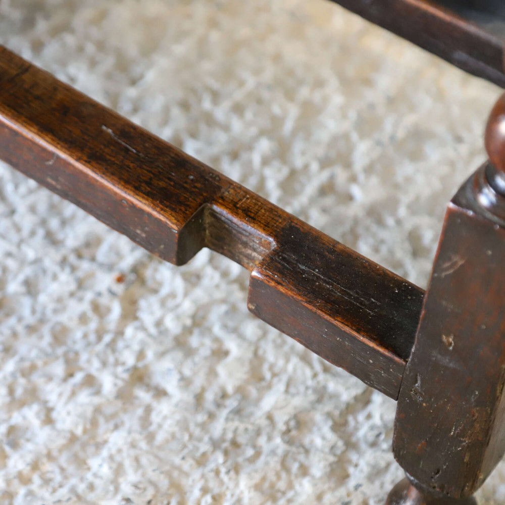 A dark oak gateleg table featuring two hinged drop leaves, bobbin turned legs, and lower box stretchers. View IX