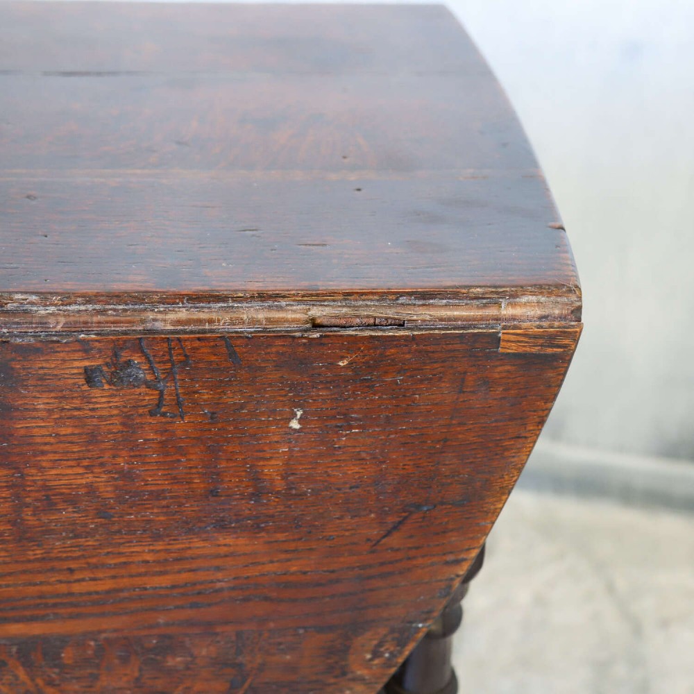 An eighteenth-century oak gateleg drop-leaf table featuring turned legs, lower stretchers, and hinged folding sides. View III