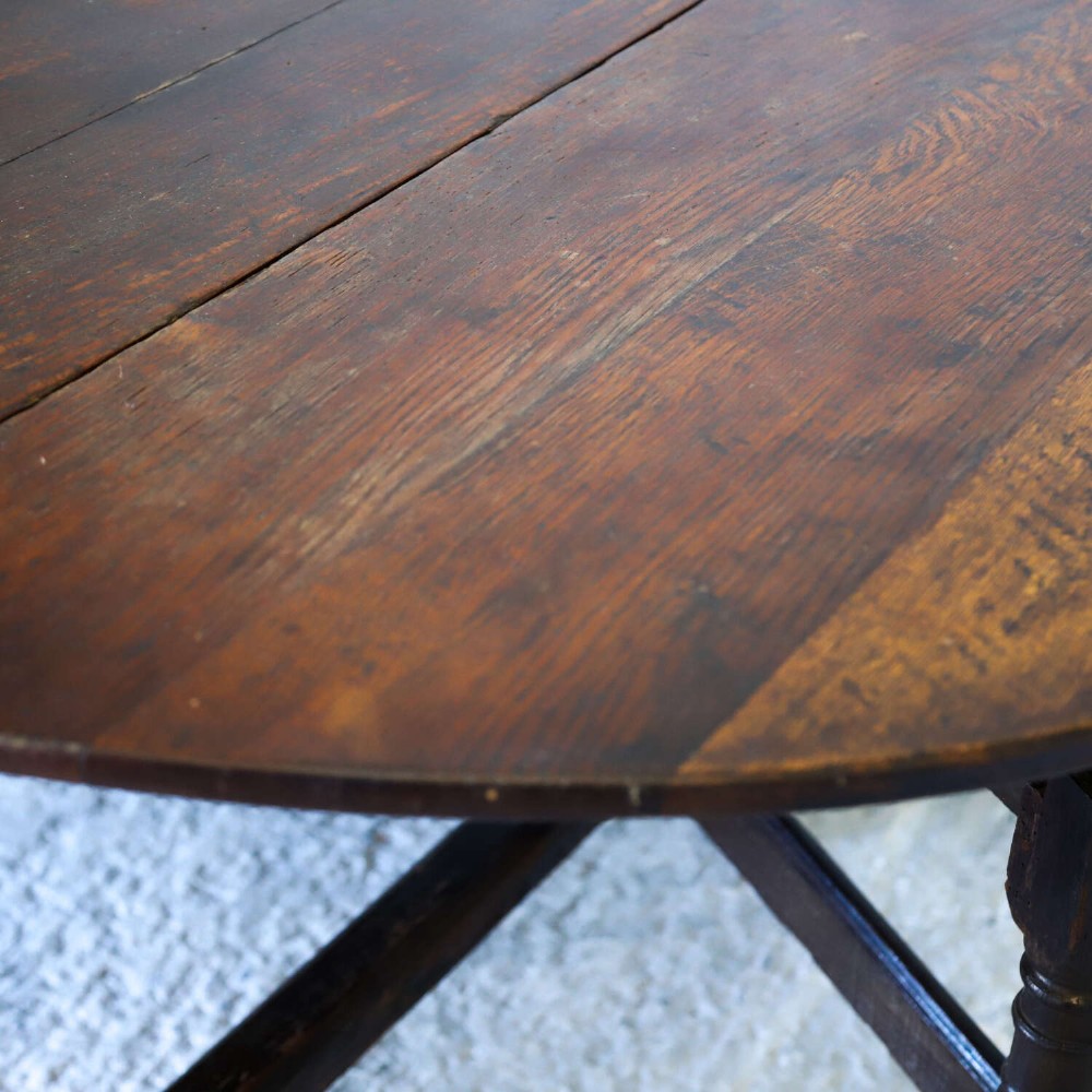 An eighteenth-century oak gateleg drop-leaf table featuring turned legs, lower stretchers, and hinged folding sides. View XIV