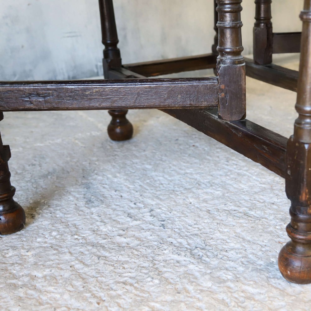 An eighteenth-century oak gateleg drop-leaf table featuring turned legs, lower stretchers, and hinged folding sides. View XV