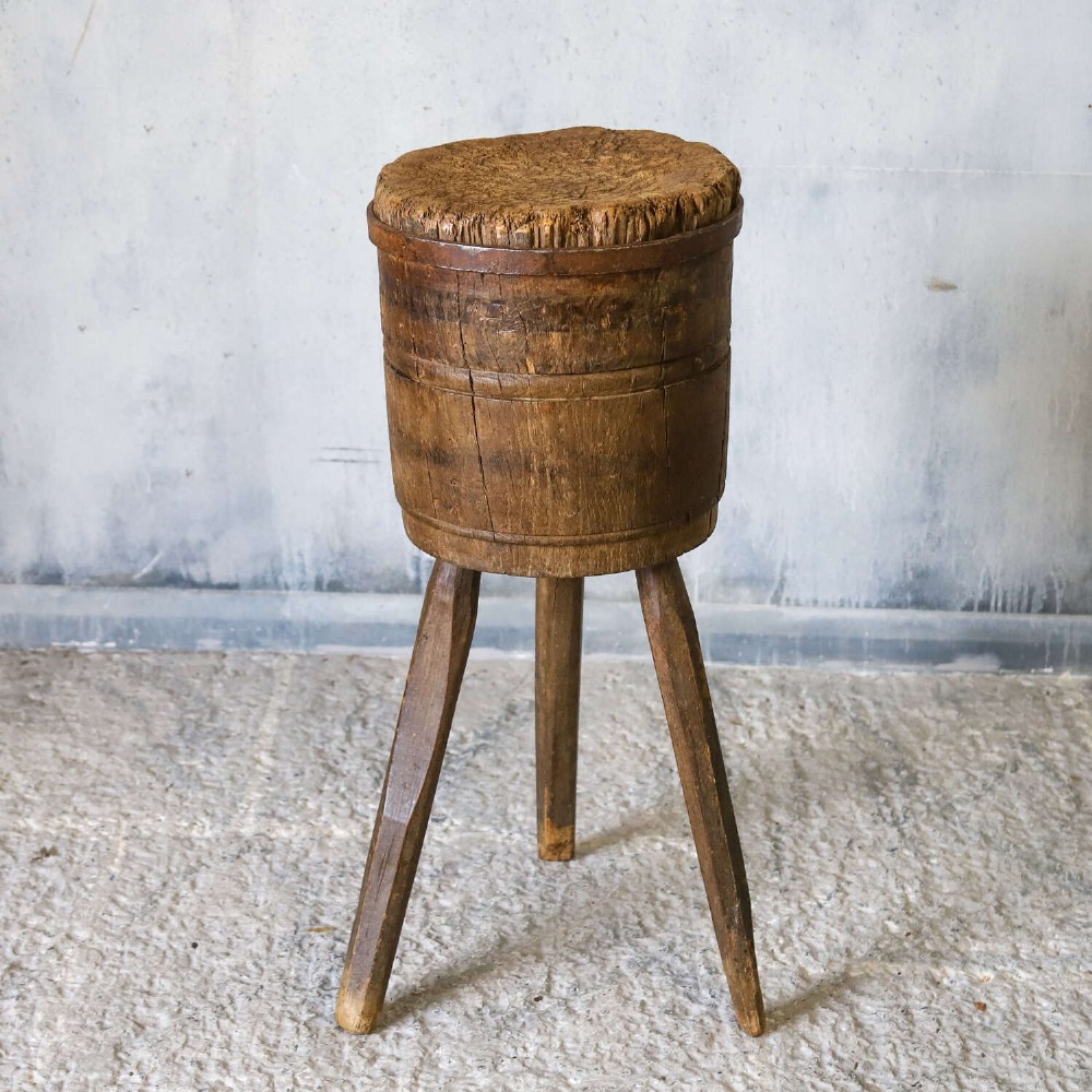A rustic three-legged French chopping block made from oak and elm with a textured wooden top. View II