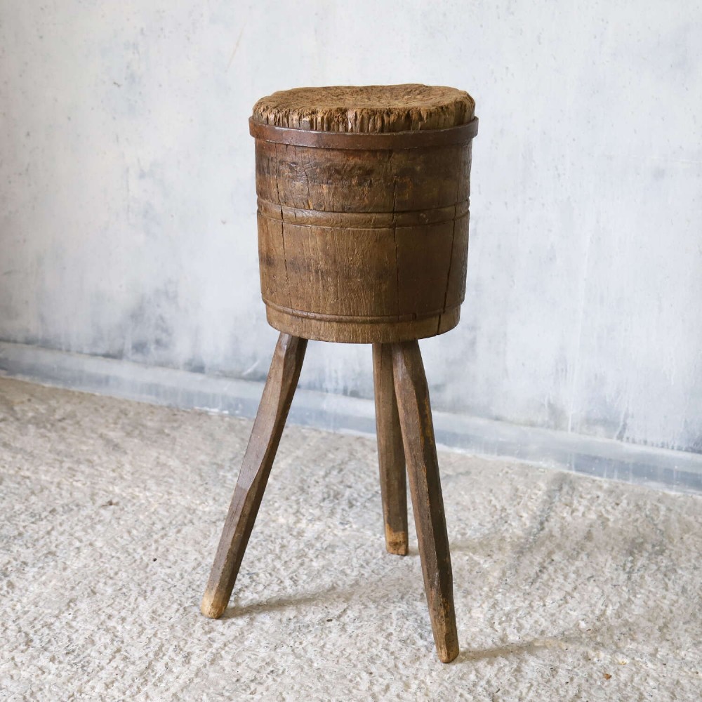 A rustic three-legged French chopping block made from oak and elm with a textured wooden top. View III