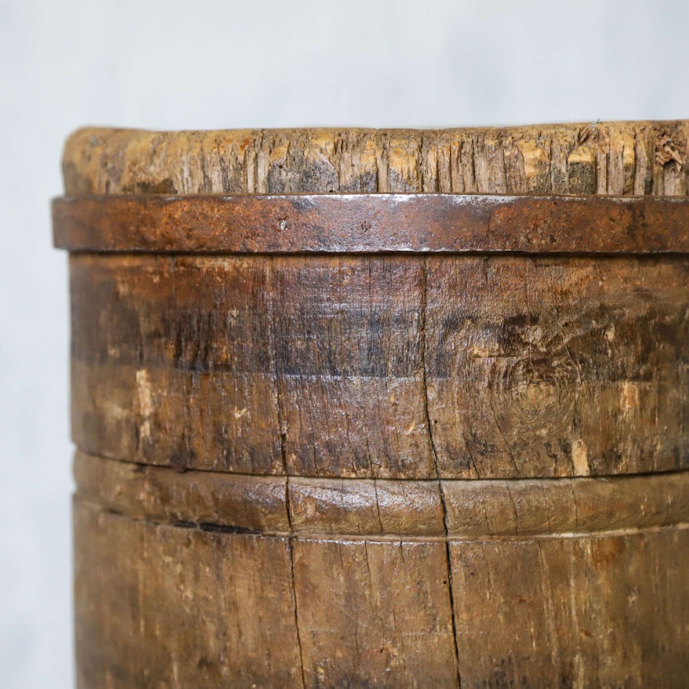 A rustic three-legged French chopping block made from oak and elm with a textured wooden top. View VI