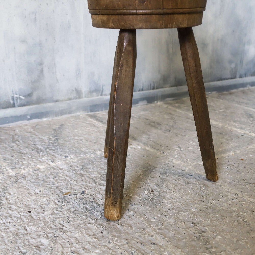 A rustic three-legged French chopping block made from oak and elm with a textured wooden top. View VII