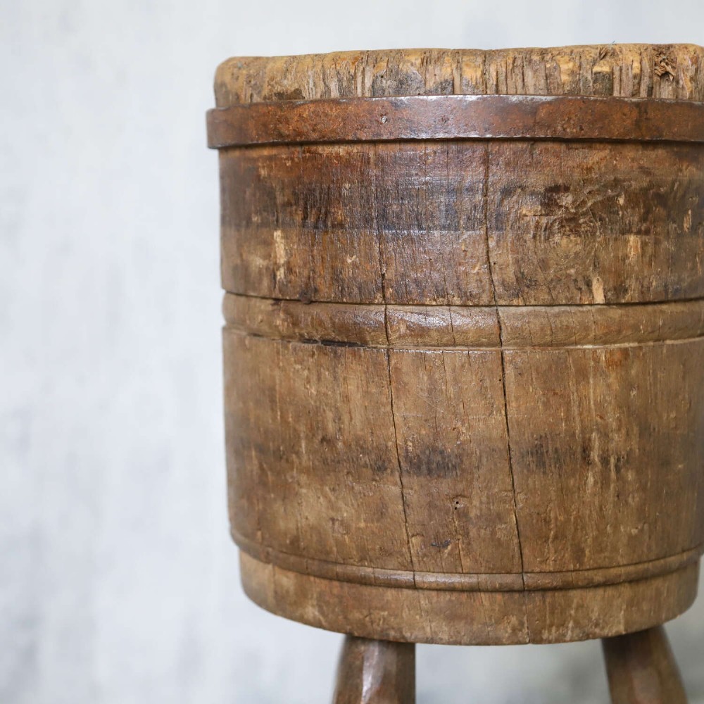 A rustic three-legged French chopping block made from oak and elm with a textured wooden top. View VIII